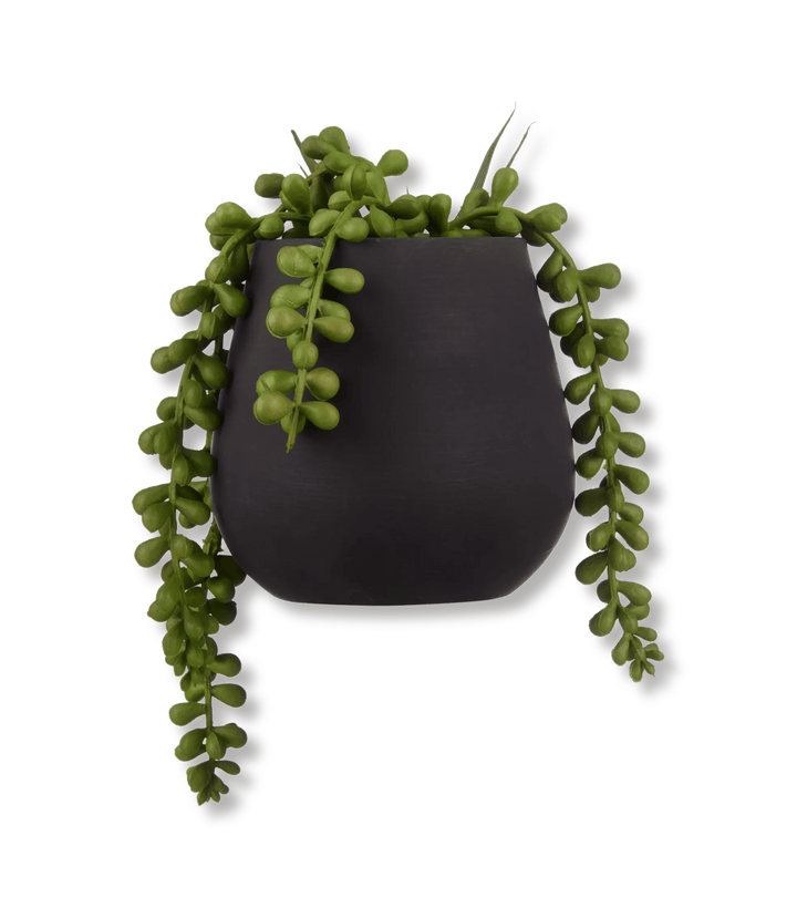 Plante artificielle dans un pot en céramique noir